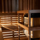 Homecraft H-Series Electric Sauna Heater Wooden sauna interior with a heater and bench