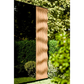 Wavy patterned fabric hanging against a green leafy background